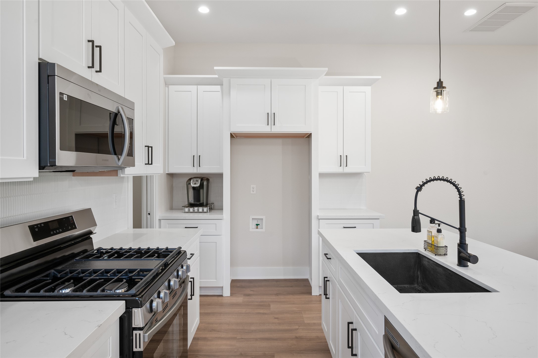921 East 38th Street Houston, TX 77022 - Photo 10 of 40 a kitchen with stainless steel appliances kitchen island a stove a sink and a microwave