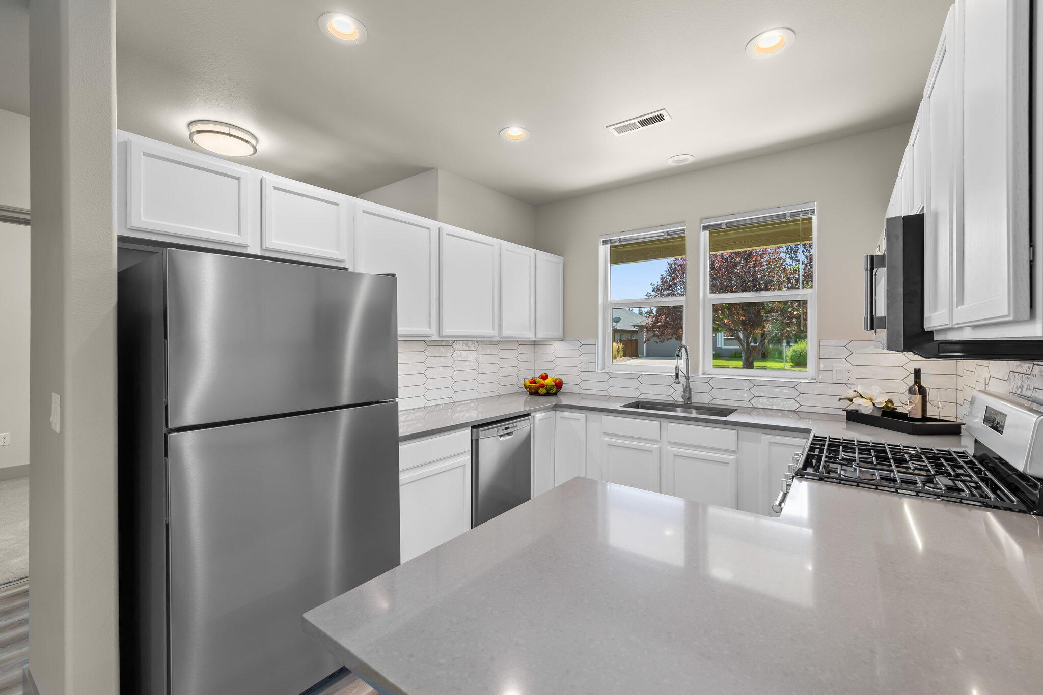 3108 Yellow Ribbon Drive Bend, OR 97701 - Photo 9 of 36 a kitchen with a refrigerator a sink and cabinets