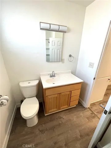 a bathroom with a sink a toilet and mirror
