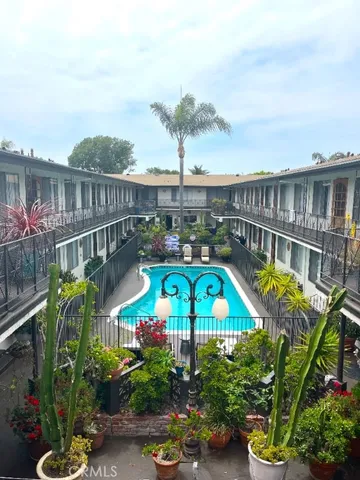a view of a swimming pool with a patio and a garden