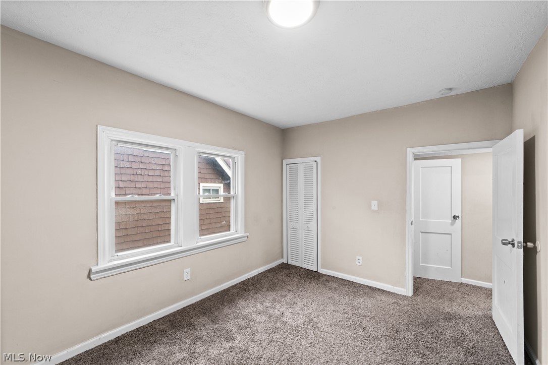 1062 Yellowstone Road Cleveland Heights, OH 44121 - Photo 21 of 29 Unfurnished bedroom featuring a closet and dark colored carpet