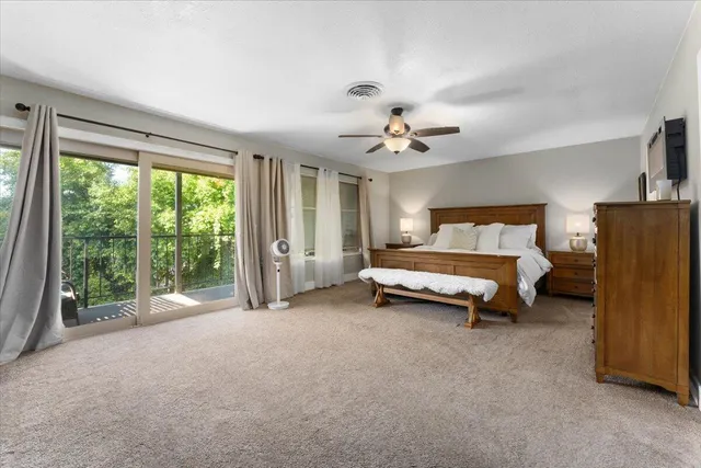 a bed room with a bed and a large window