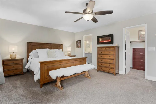 a bed room with a bed and a chair