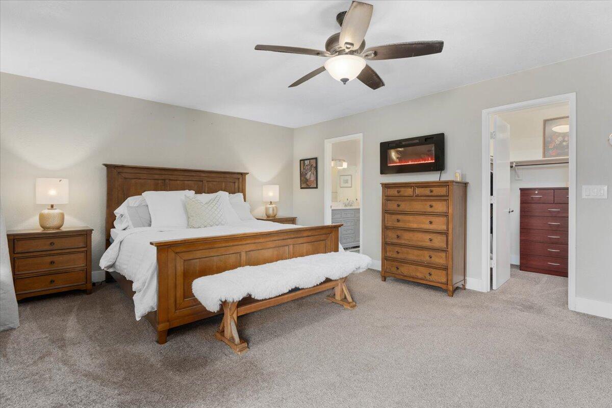 1968 Bechelli Lane Redding, CA 96002 - Photo 13 of 32 a bed room with a bed and a chair