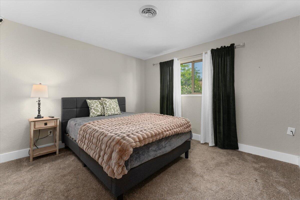 1968 Bechelli Lane Redding, CA 96002 - Photo 18 of 32 a bedroom with a bed and a window