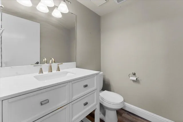 a bathroom with a sink a toilet and mirror