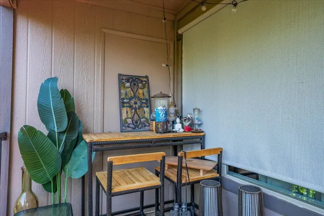 a view of a dining room with furniture and a potted plant