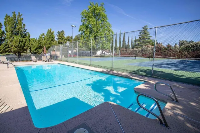 a view of a backyard with swimming pool