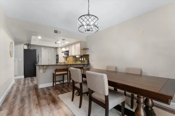 a view of a dining room with furniture wooden floor and a chandelier