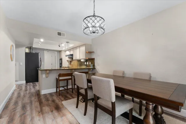 a view of a dining room with furniture wooden floor and a chandelier
