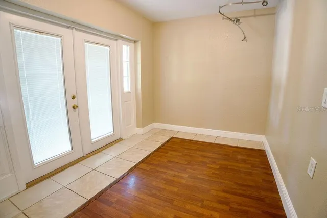 a view of a room with wooden floor and cabinet