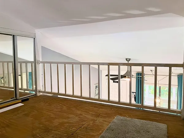 a living room with furniture and a mirror
