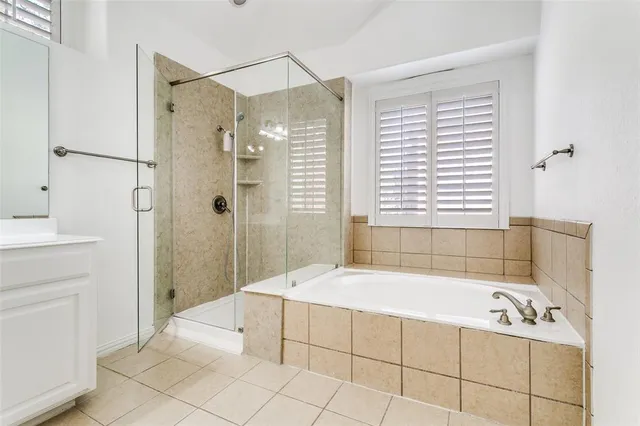a spacious bathroom with a bathtub and a shower