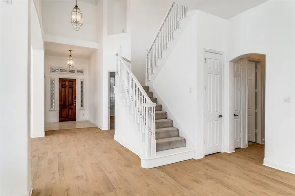 a view of a hallway with wooden floor and entryway