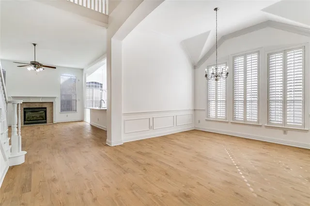 a view of an empty room with a fireplace and a window