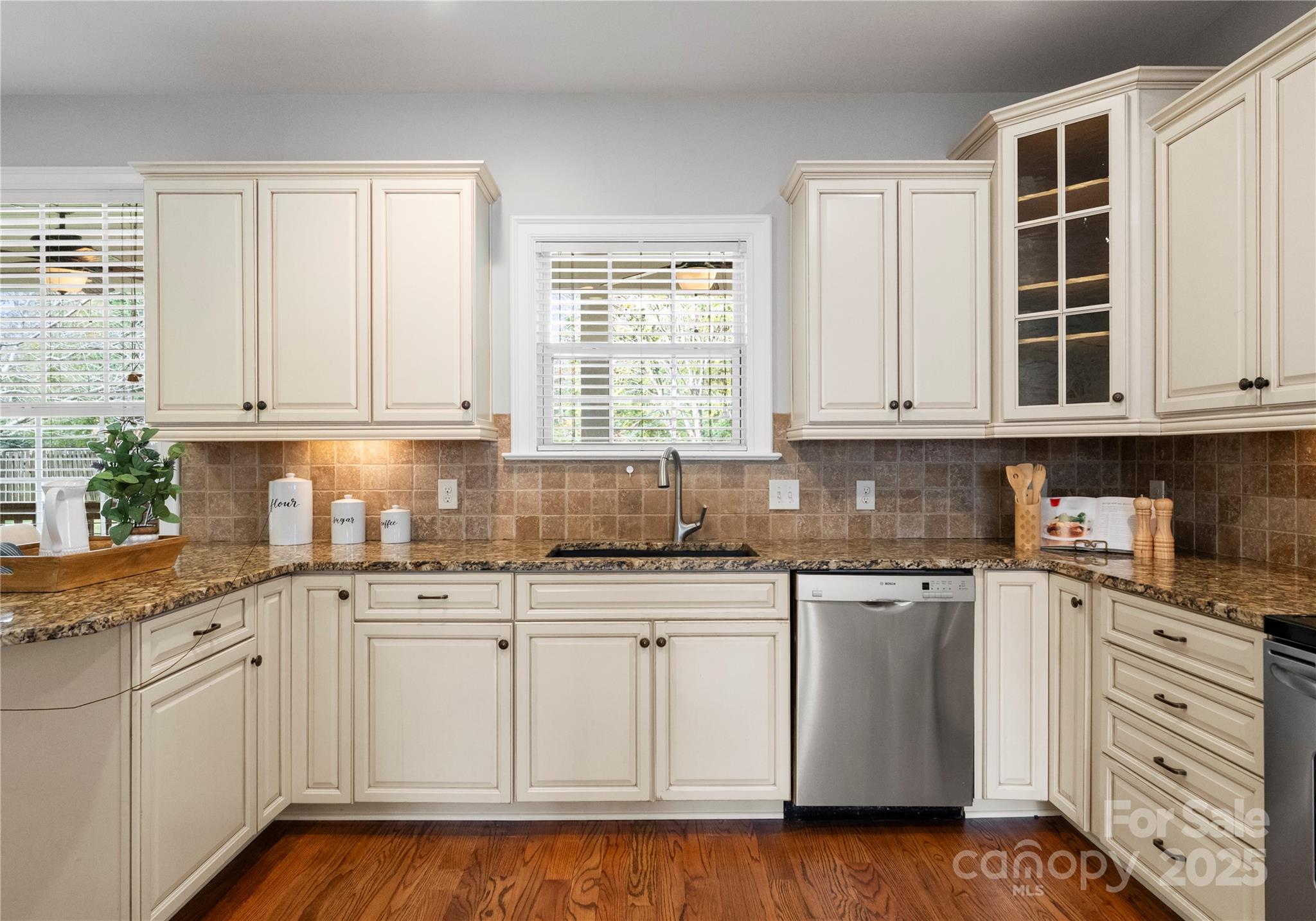2105 Lanier Avenue Charlotte, NC 28205 - Photo 11 of 31 a kitchen with granite countertop white cabinets and sink