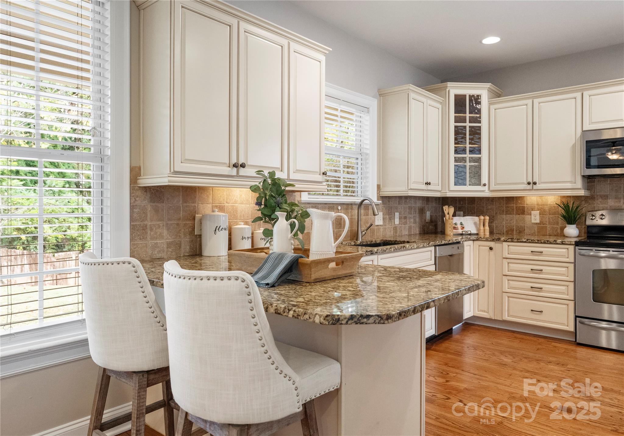 2105 Lanier Avenue Charlotte, NC 28205 - Photo 12 of 31 a kitchen with kitchen island granite countertop a sink cabinets and window