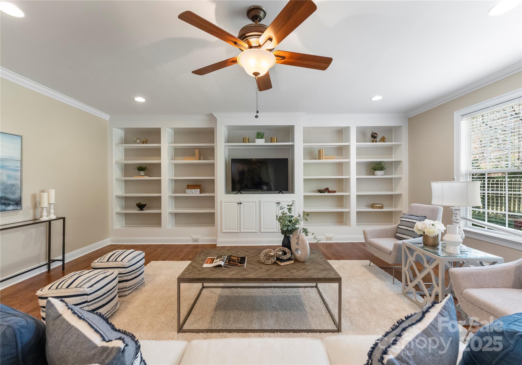 2105 Lanier Avenue Charlotte, NC 28205 - Photo 15 of 31 a living room with furniture a ceiling fan a flat screen tv and a window