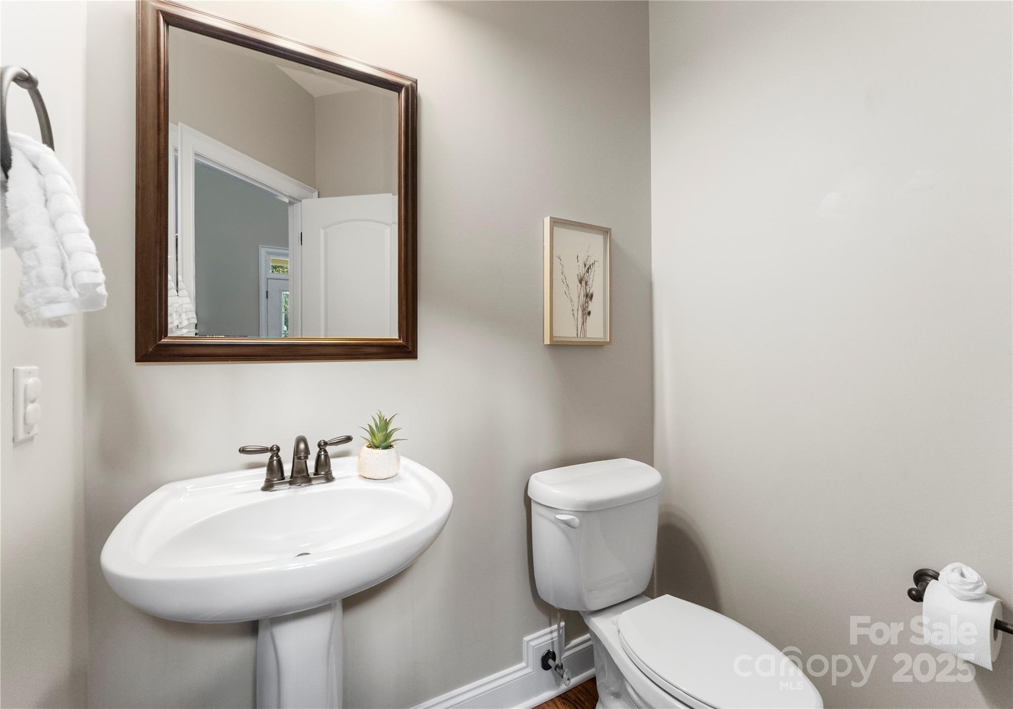 2105 Lanier Avenue Charlotte, NC 28205 - Photo 18 of 31 a bathroom with a toilet a sink and mirror