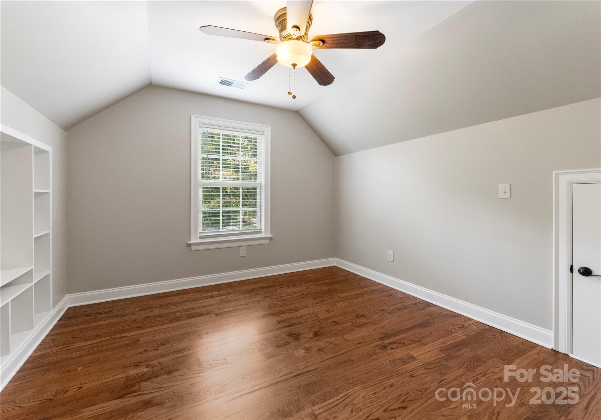 2105 Lanier Avenue Charlotte, NC 28205 - Photo 28 of 31 a view of an empty room with window and a chandelier fan