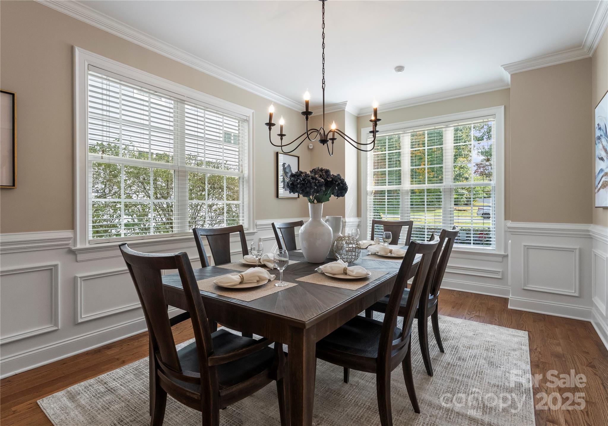 2105 Lanier Avenue Charlotte, NC 28205 - Photo 9 of 31 a dining room with furniture a chandelier and wooden floor
