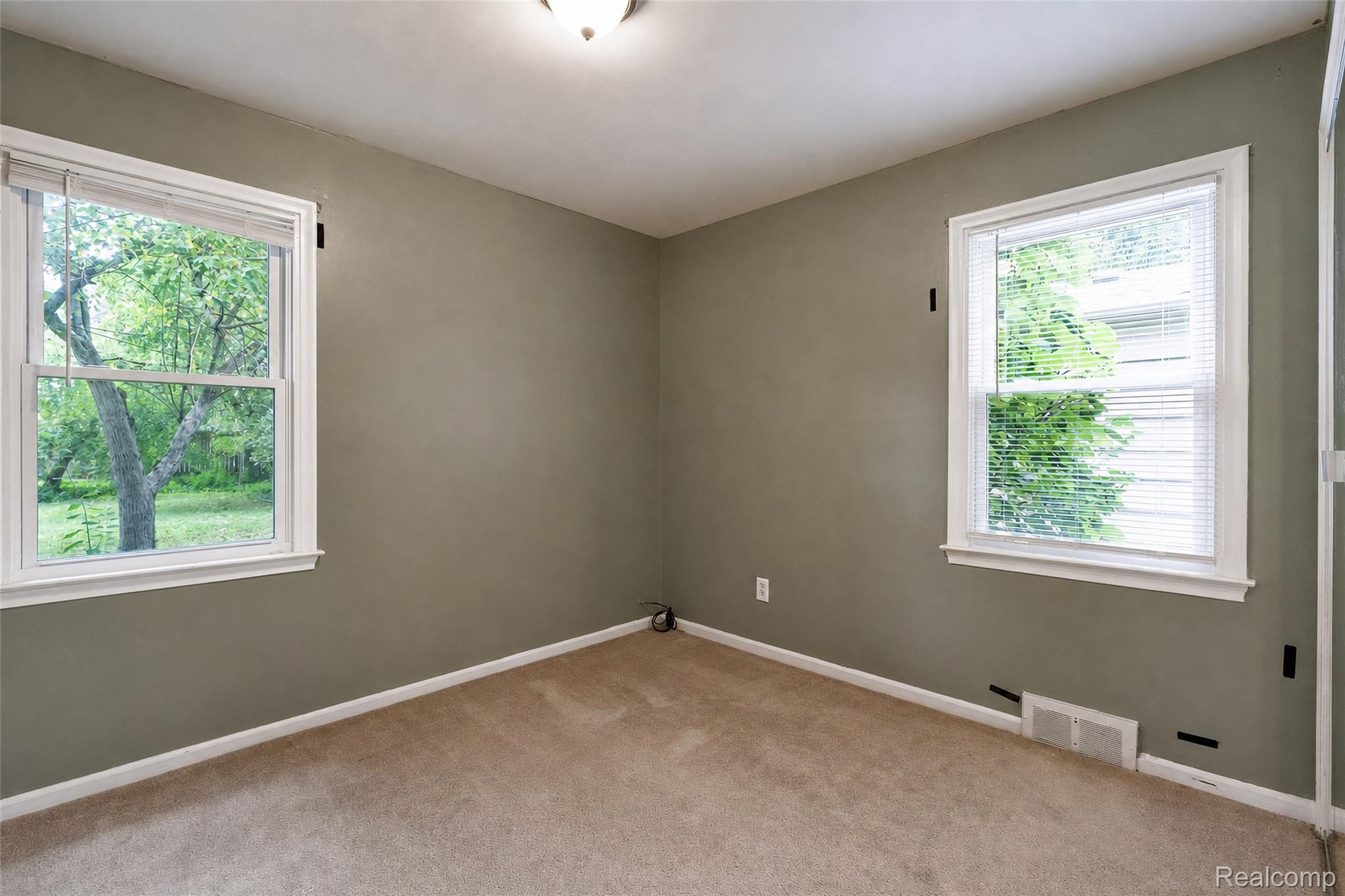 1846 Pembroke Road Birmingham, MI 48009 - Photo 35 of 37 Neutral-toned carpeting, two windows with white trim, and a ceiling-mounted light fixture