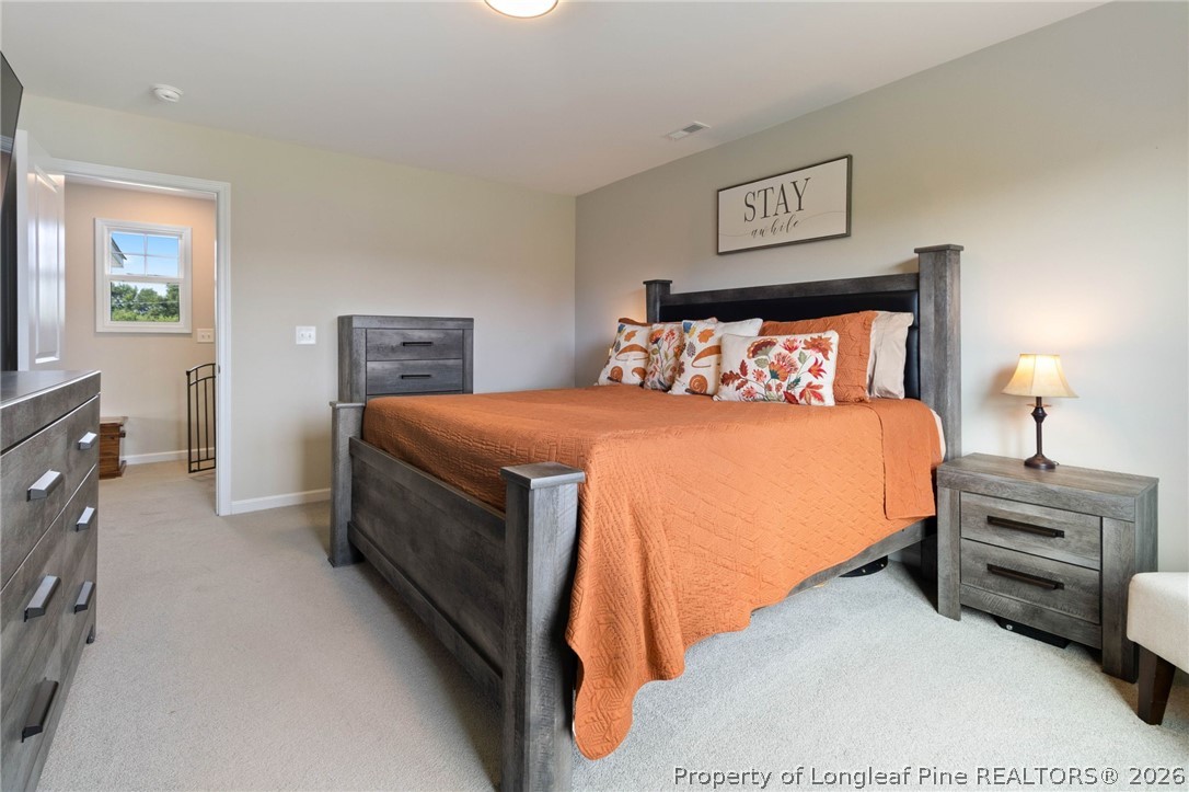 1368 Talmage Road St. Pauls, NC 28384 - Photo 12 of 26 a bedroom with a bed and a lamp on dresser