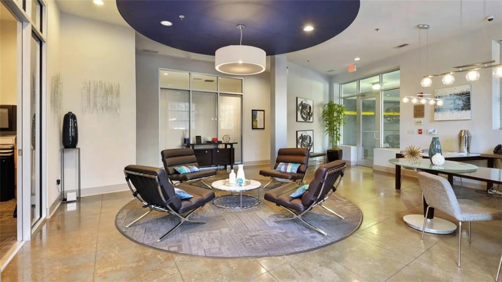 2115 Piedmont Road Northeast, Unit 2311 Atlanta, GA 30324 - Photo 11 of 14 a living room with couches a table and chairs with kitchen view