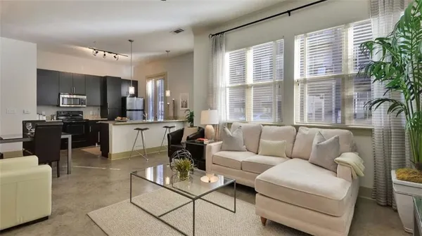 a living room with furniture and a large window