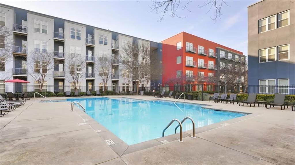 2115 Piedmont Road Northeast, Unit 2311 Atlanta, GA 30324 - Photo 10 of 14 a swimming pool with outdoor seating and yard
