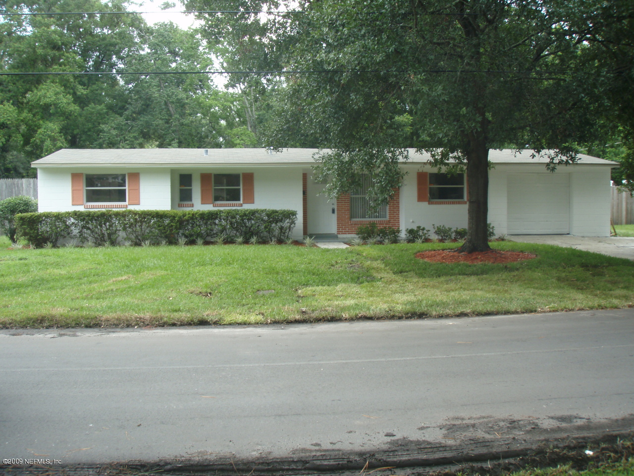 4238 Glenview Road Jacksonville, FL 32207 - Photo 3 of 6 a front view of a house with a yard and garage