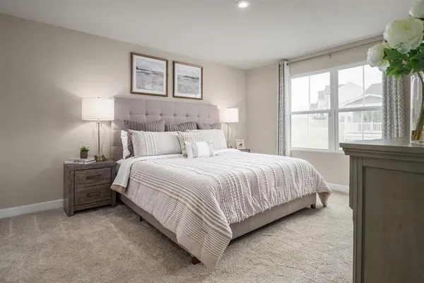 a bedroom with a bed and a large window