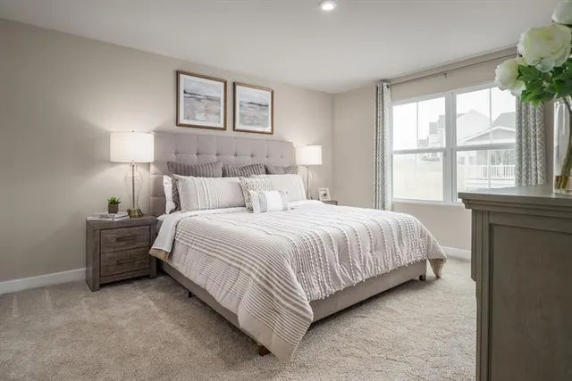 a bedroom with a bed and a large window