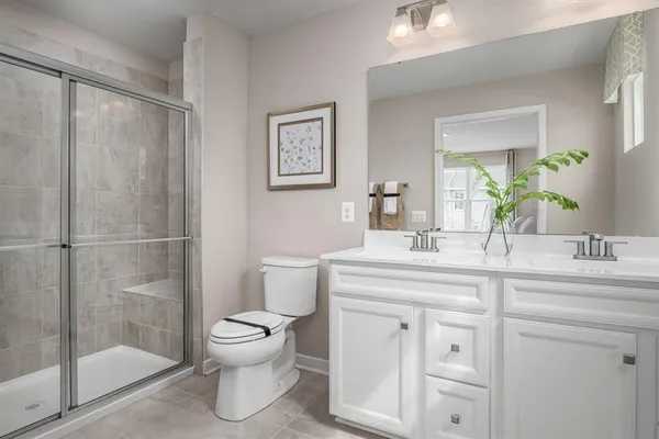 a bathroom with a toilet sink and shower