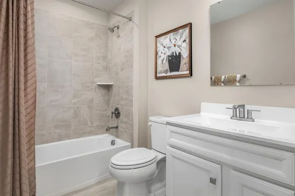 a bathroom with a sink a toilet and a bathtub