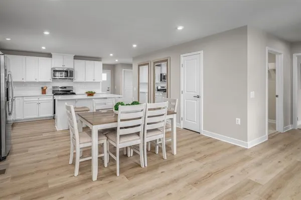 a kitchen with a table and chairs in it