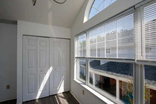 a kitchen with granite countertop a stove and a white wooden cabinets