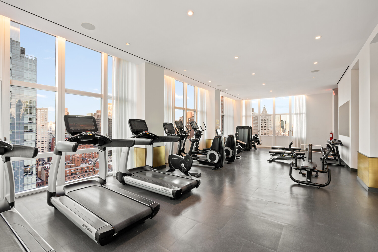 305 East 51st Street, Unit RU5H Manhattan, NY 10022 - Photo 12 of 14 a living room with furniture and floor to ceiling windows