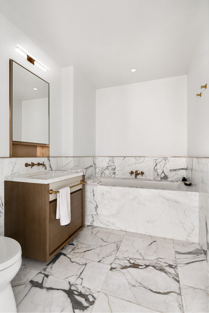 305 East 51st Street, Unit RU5H Manhattan, NY 10022 - Photo 5 of 14 a bathroom with a sink toilet and mirror