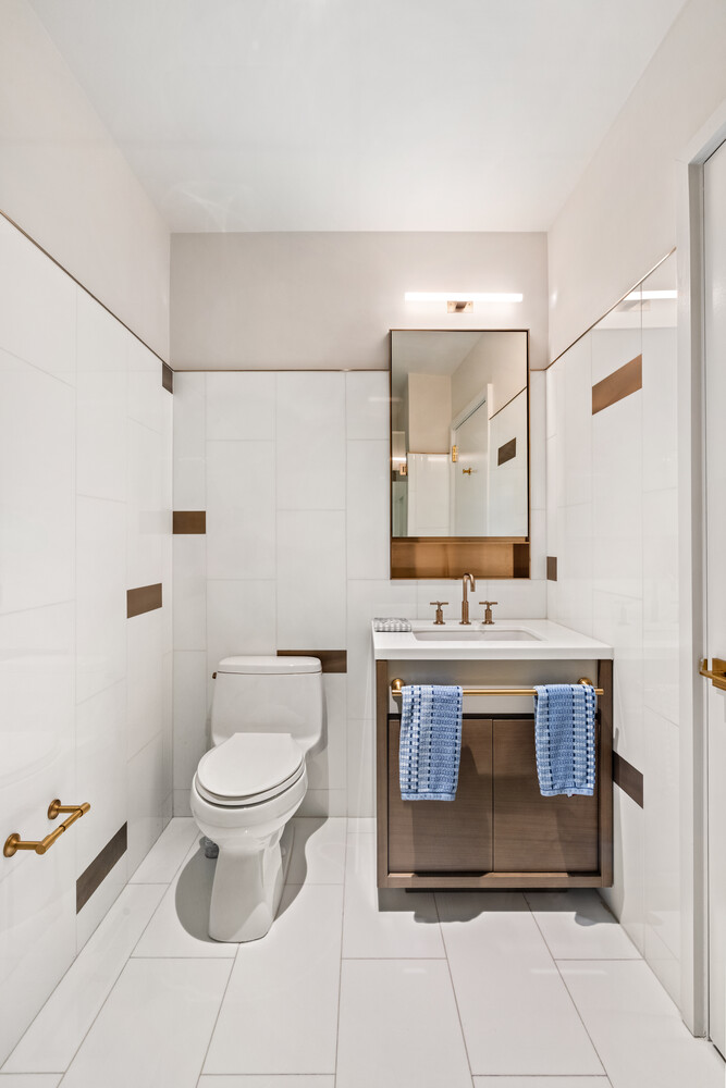 305 East 51st Street, Unit RU5H Manhattan, NY 10022 - Photo 8 of 14 a bathroom with a sink toilet and mirror