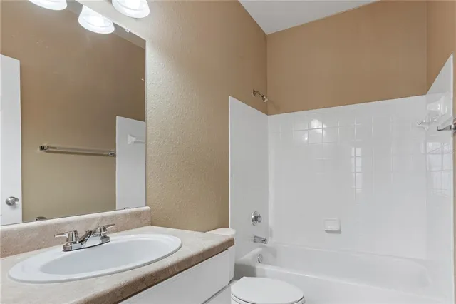 a view of a livingroom with furniture staircase wooden floor and windows