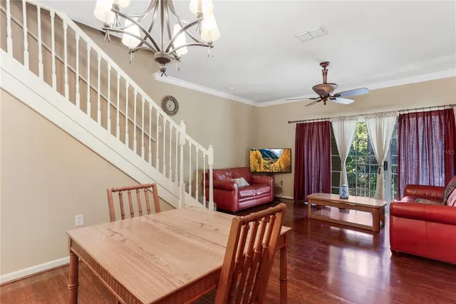 a living room with furniture a fireplace and a chandelier