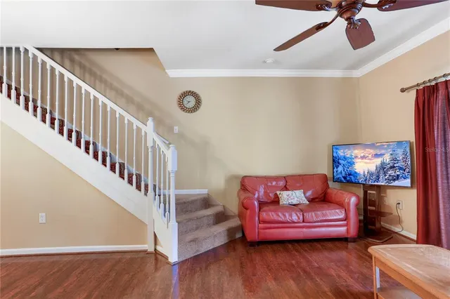 a living room with furniture and wooden floor