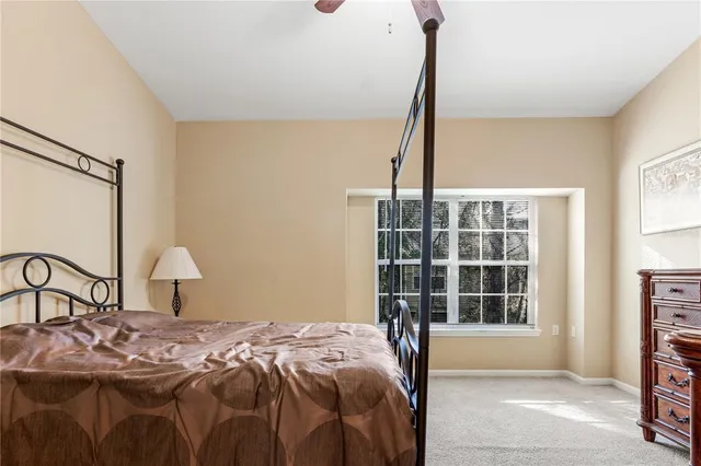 a bedroom with a bed window and a table