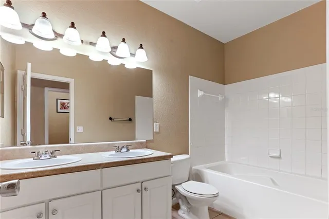 a bathroom with a double vanity sink and a toilet