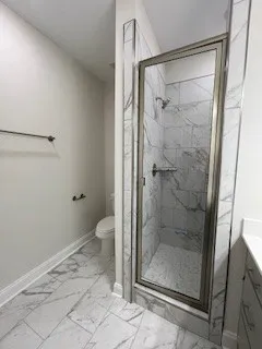 a bathroom with a glass shower door