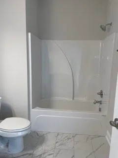 a bathroom with a bathtub and a toilet