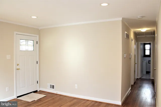 a view of a room with wooden floor