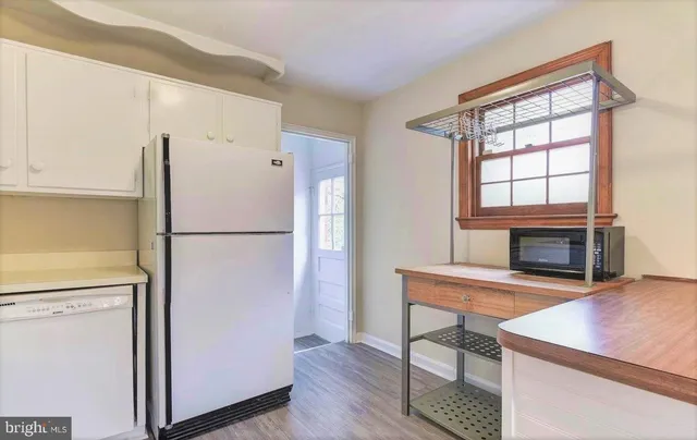 a kitchen with a refrigerator a stove and a microwave