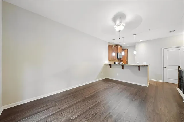 a view of a kitchen with wooden floor and a chandelier